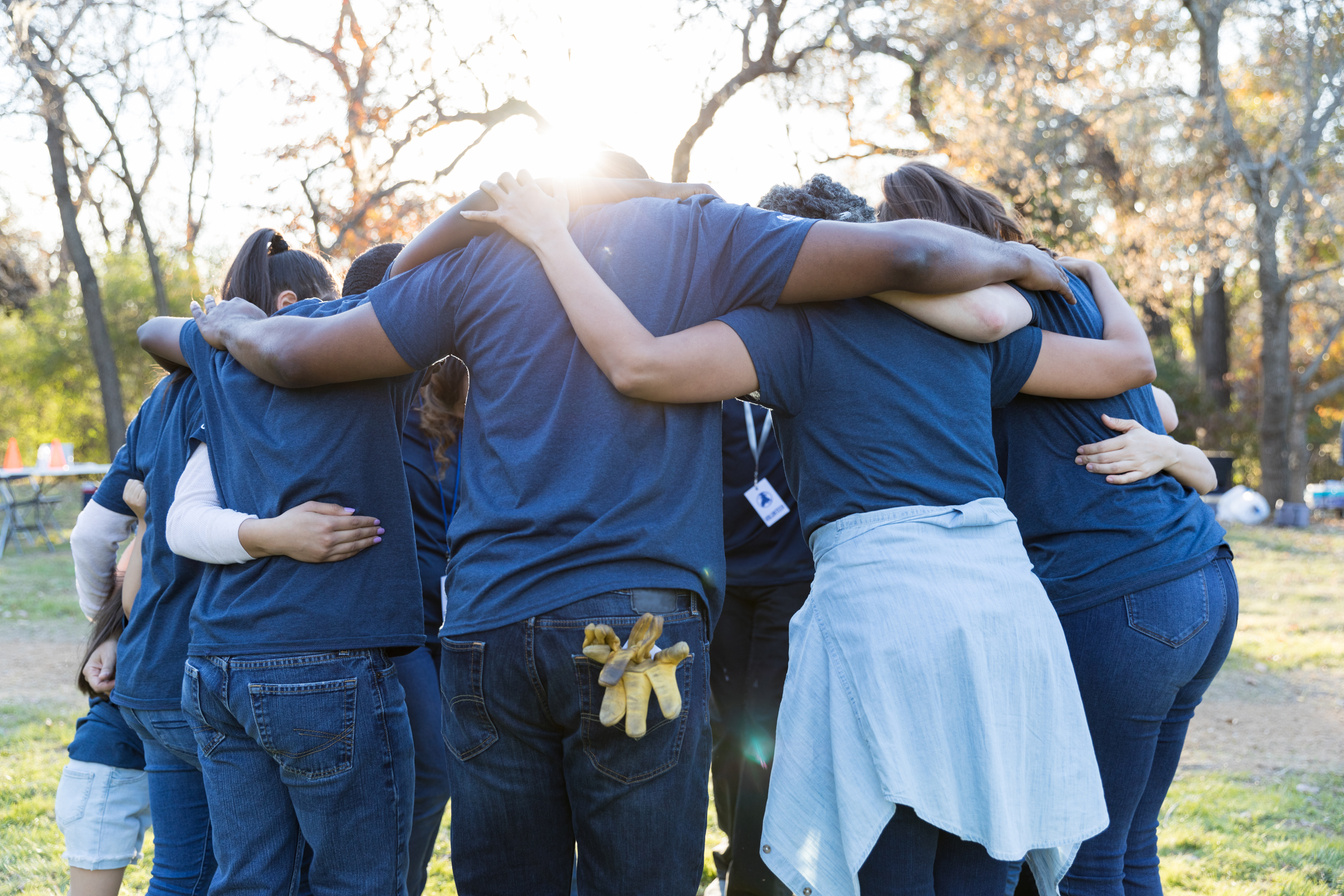 Volunteers huddle together during community cleanup day